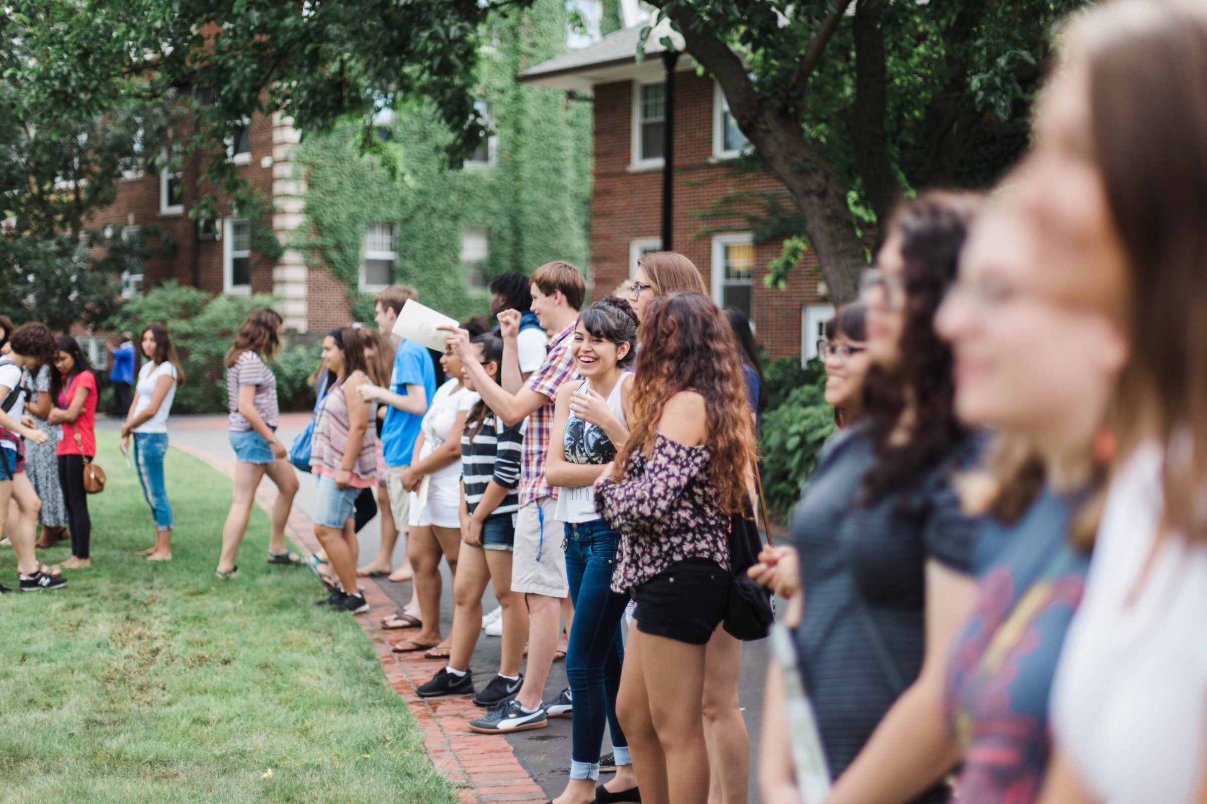 Students line up on the grass during orientation group activities.
