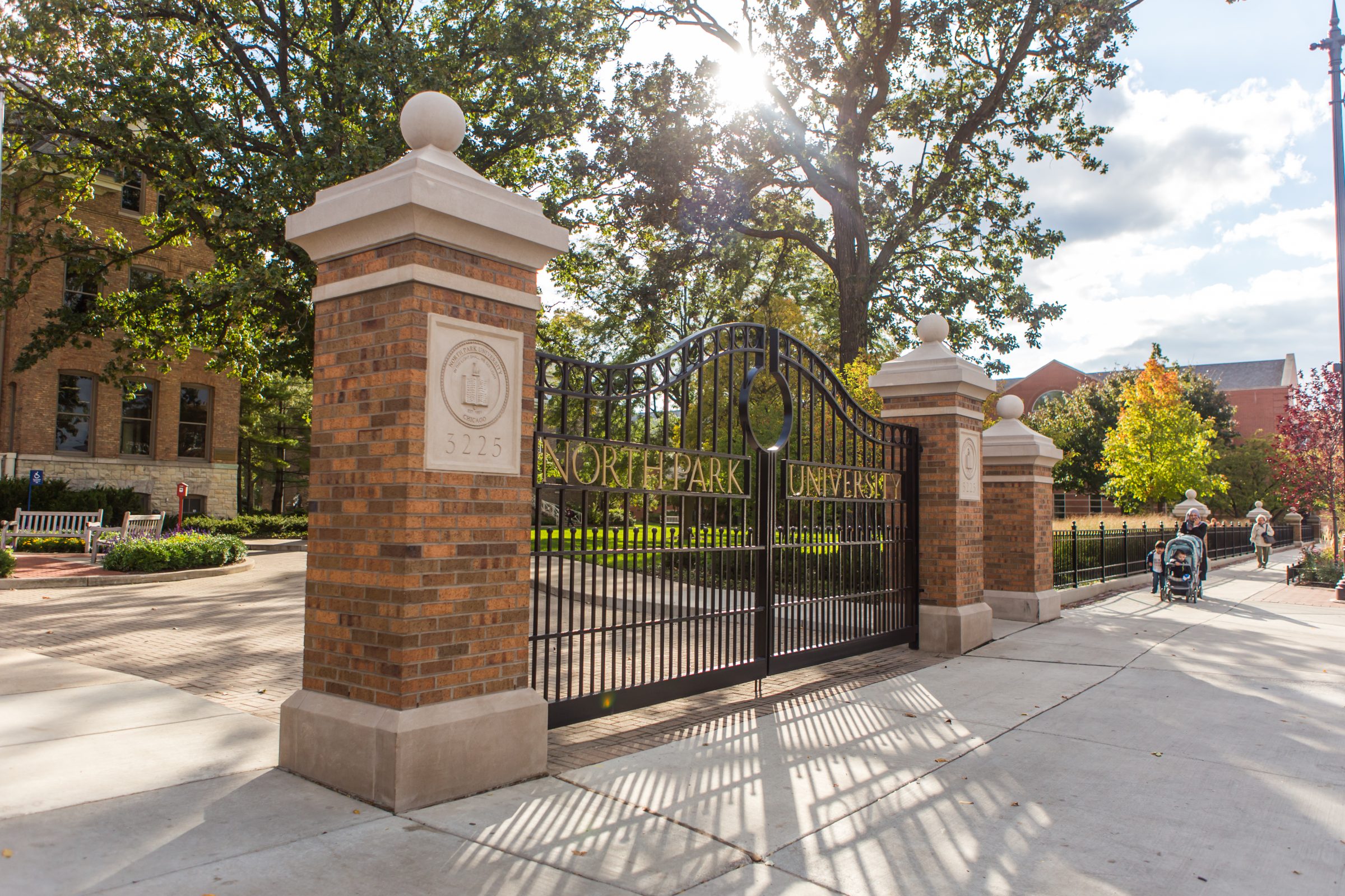 Nursing and Health Sciences at North Park, brick building and gate at the front of campus.