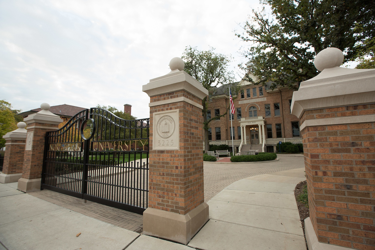 The brick columns and gate at the front of campus bearing the school's name in Gold.