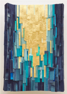 Three-dimensional art piece made out of strips of gold and blue paper.