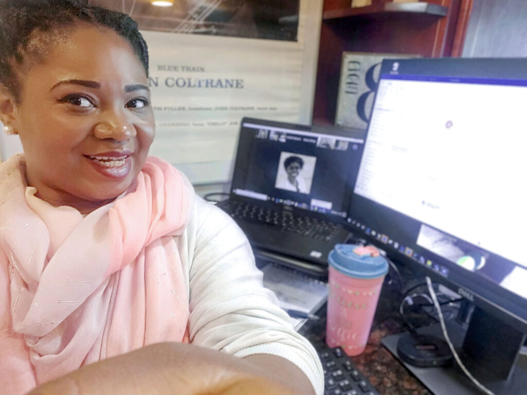 Woman sitting at home office desk.