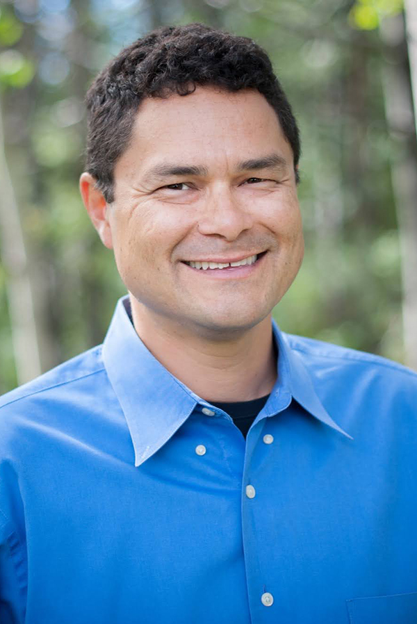 Smiling man in blue dress shirt