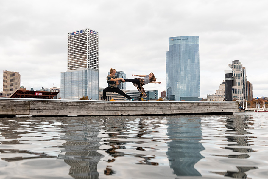 Pair of male and female dancers on a pier in front of Chicago skyline