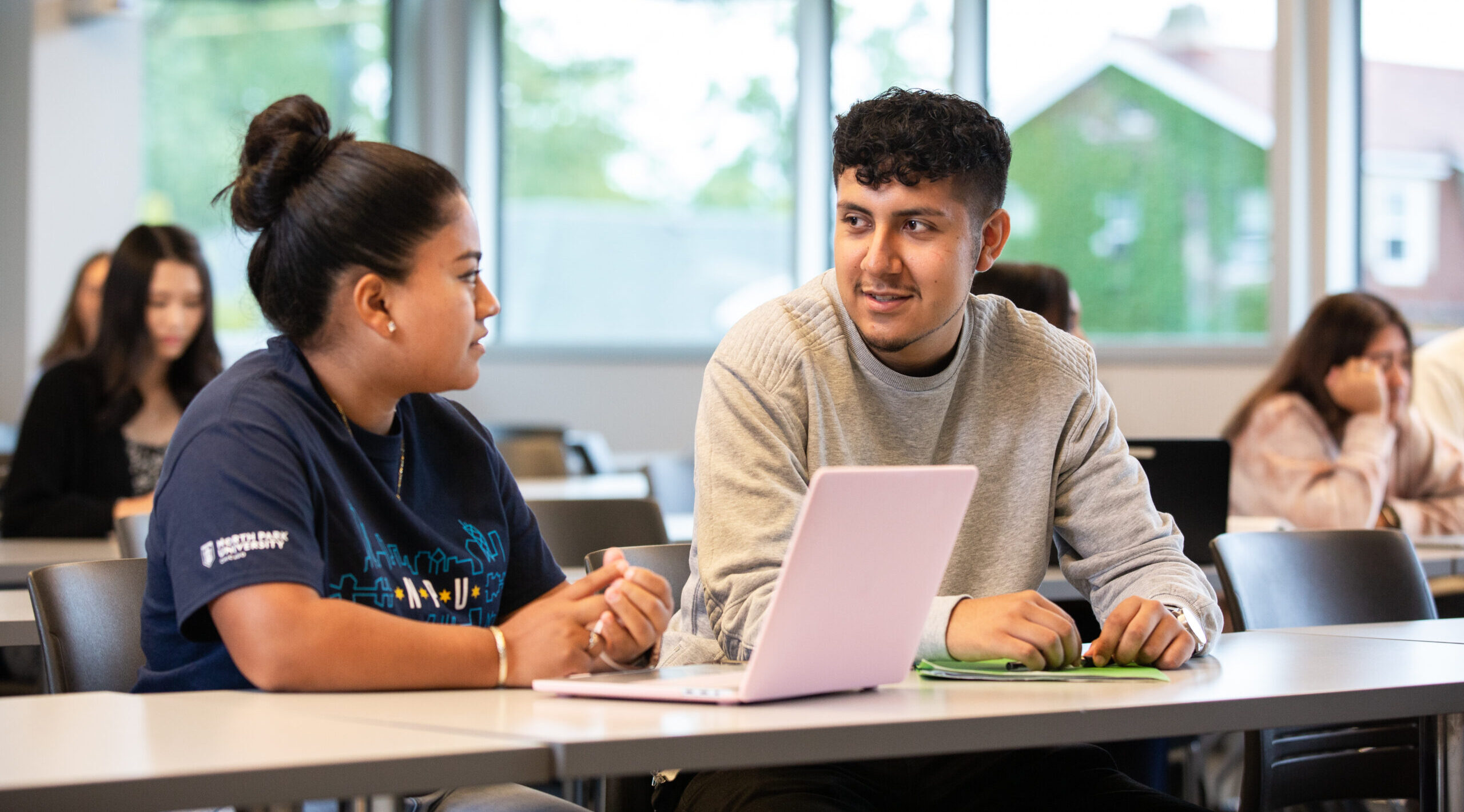 Undergraduate students working together in a classroom