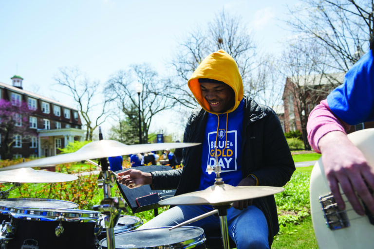 Student playing drums during Blue and Gold Day