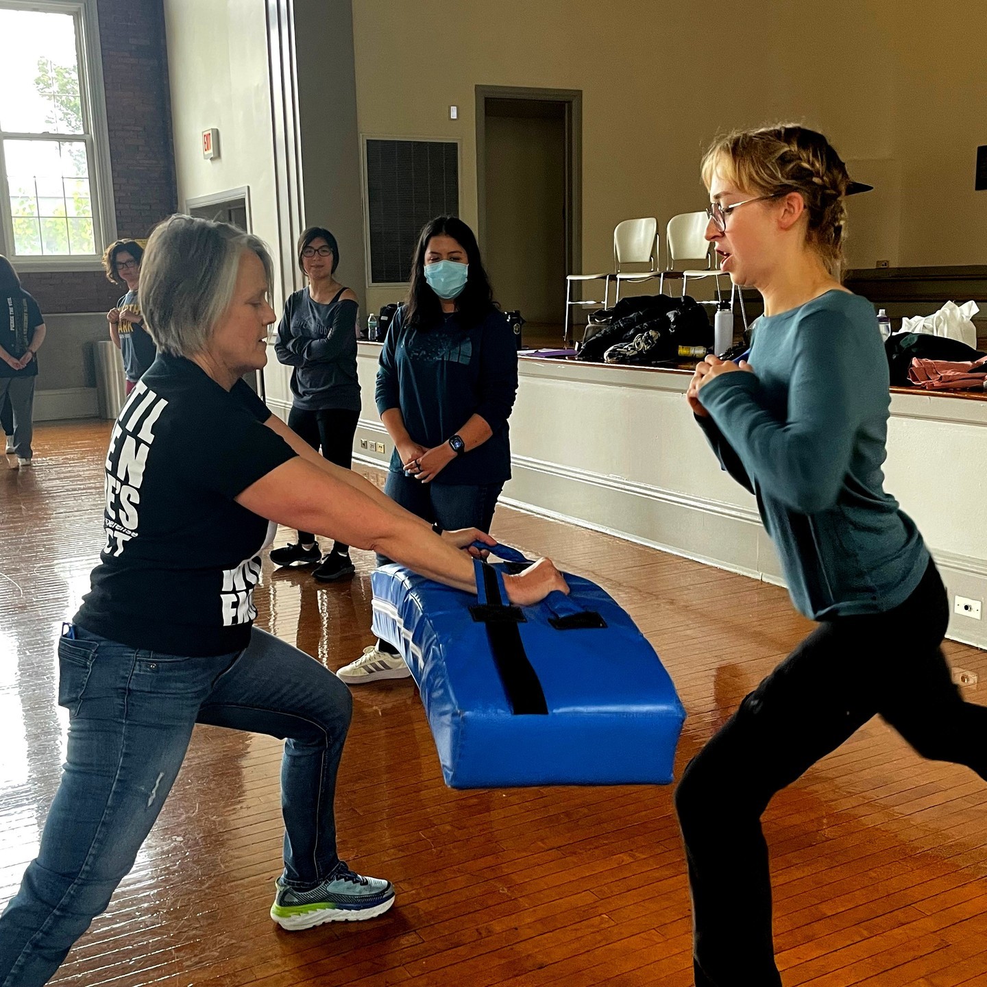 Students learn self defense in a workshop