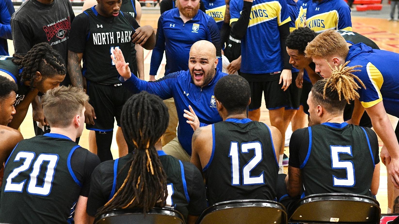 Sean Smith, basketball coach, talks to team.