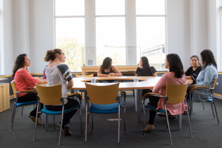 Students working together around a table in the library