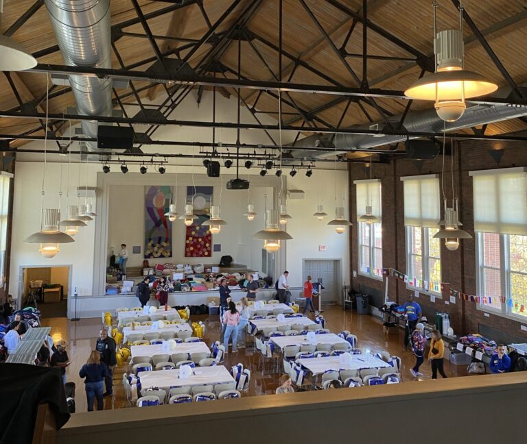 Tables and chairs set up in Hamming Hall for the attendees to enjoy a meal together.